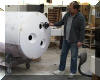 Chuck Hards holds one of the three vent fans that will be installed in the three holes visible in the tailpiece.  24 OCT 2001