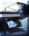 Roger Butz and Bruce Grim load parts of the "Big Scope" for transport to SPOC 2. 01 FEB 2002