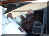 Boyd McNeil holds the mounting bolts in place as Bruce Grim installs counterweights.  03 DEC 2004 